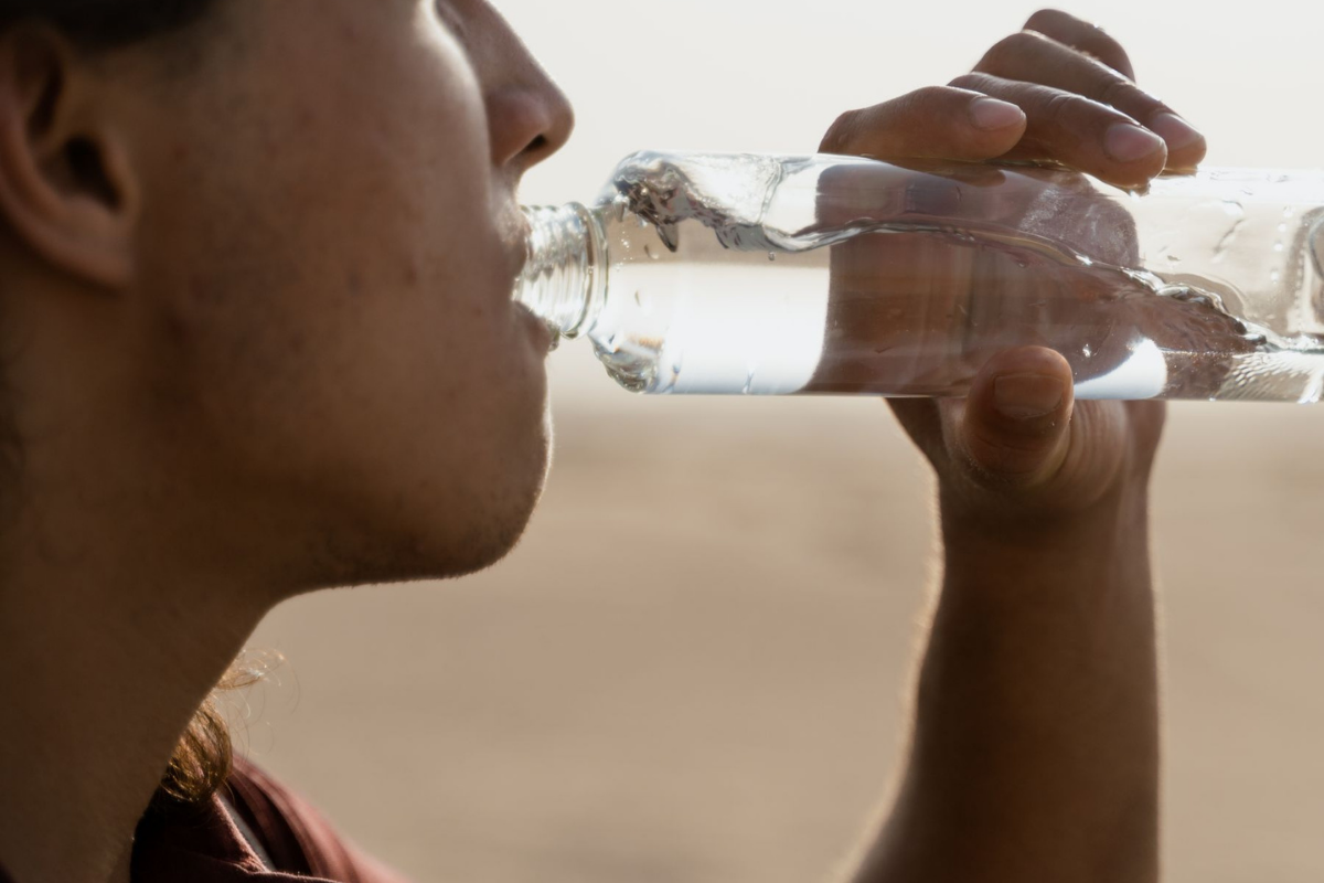 Field worker drinking water during a rest break in the heat